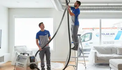 Technician cleaning air ducts for HVAC system in Milwaukee, WI home | Five Star Cooling